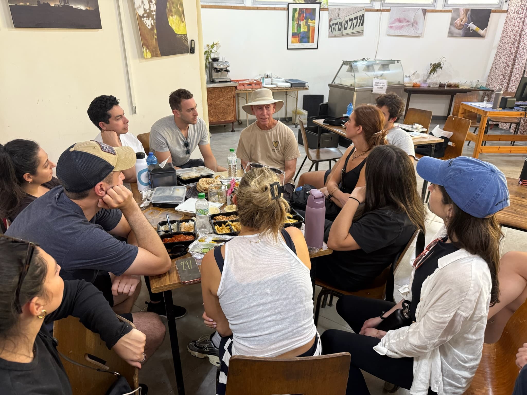 Community members gathered around a table inside Cactus Cafe